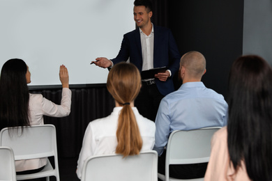 Photo of Business people at seminar in conference room with video projection screen