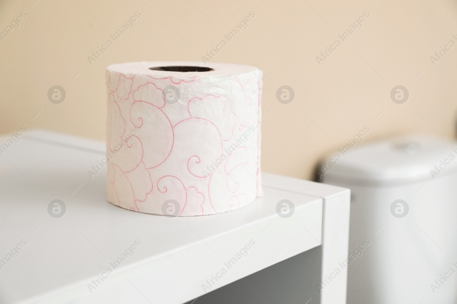 Photo of Toilet paper roll on cabinet in bathroom. Space for text