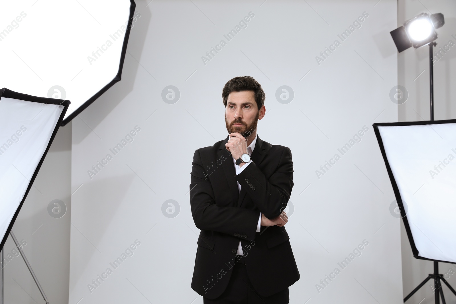 Photo of Handsome model posing in modern studio. Professional photo session