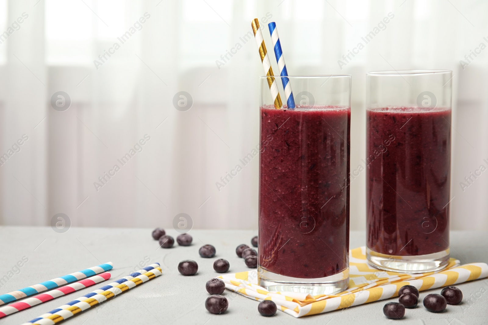 Photo of Glasses with delicious acai smoothie on table