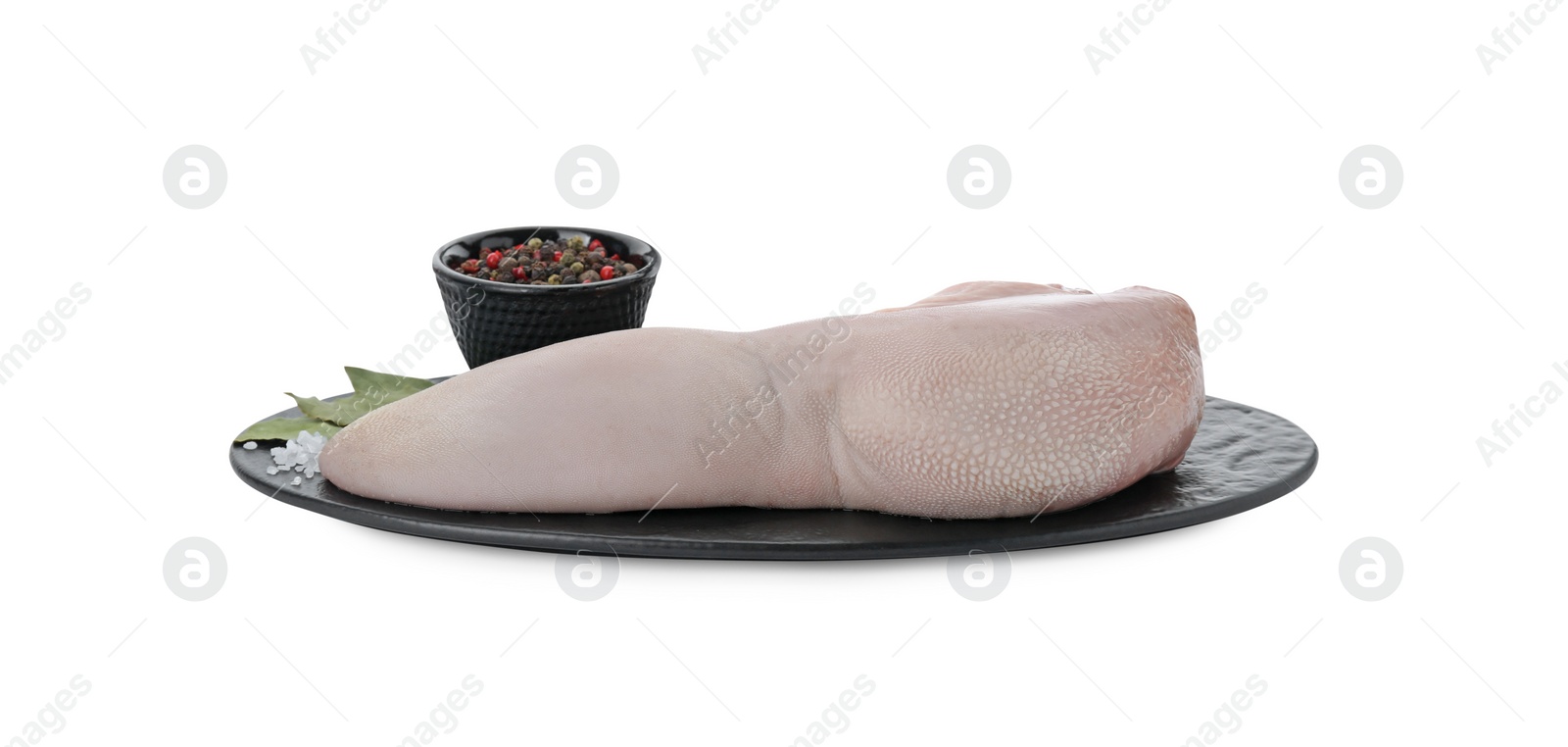 Photo of Serving board with raw beef tongue, peppercorns and bay leaves on white background