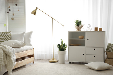 Photo of Stylish chest of drawers in bedroom interior