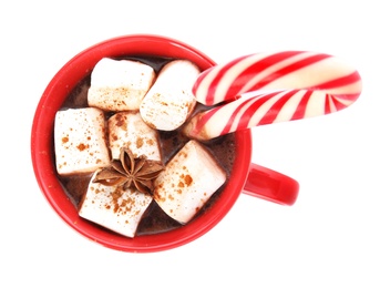 Photo of Cup of hot chocolate with marshmallows, Christmas candy cane and anise isolated on white, top view