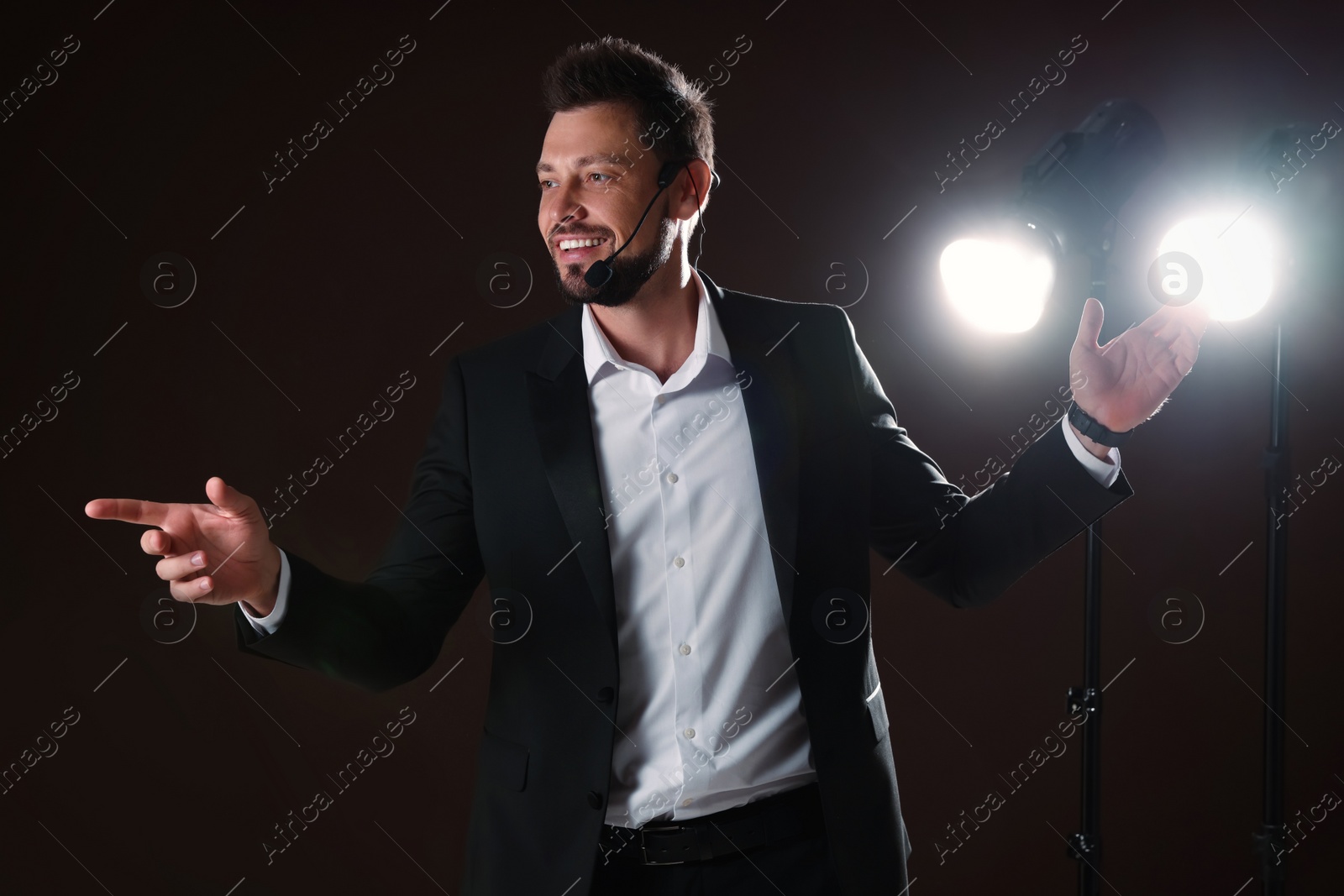 Photo of Motivational speaker with headset performing on stage