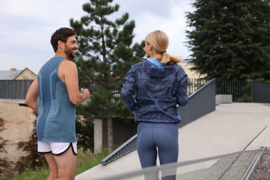 Photo of Healthy lifestyle. Happy sporty couple running outdoors