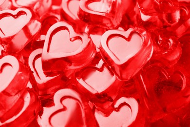 Photo of Many red heart shaped jelly candies as background, closeup