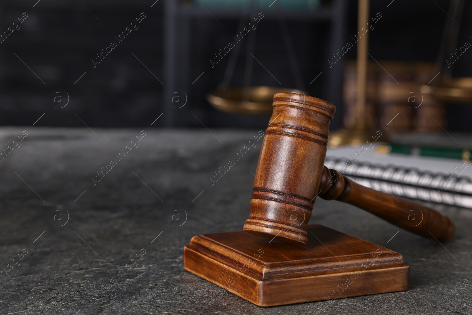 Photo of Law concept. Judge's gavel on grey textured table, space for text