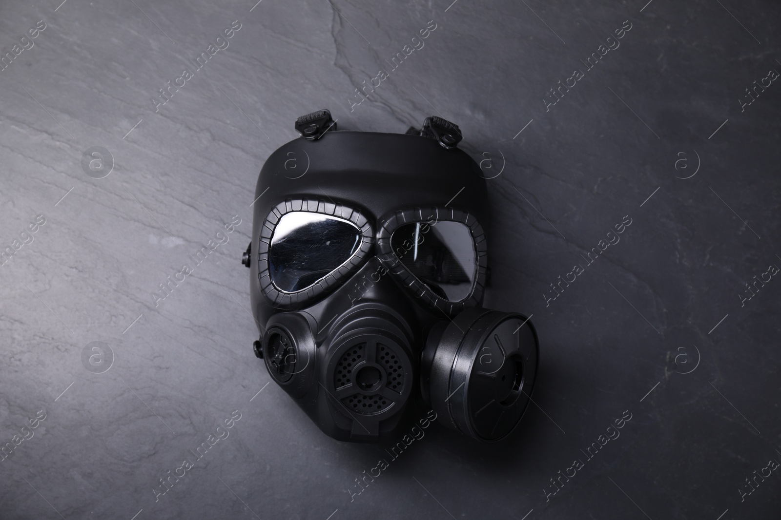 Photo of One gas mask on grey textured background, top view