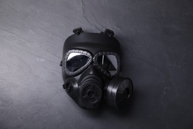 One gas mask on grey textured background, top view