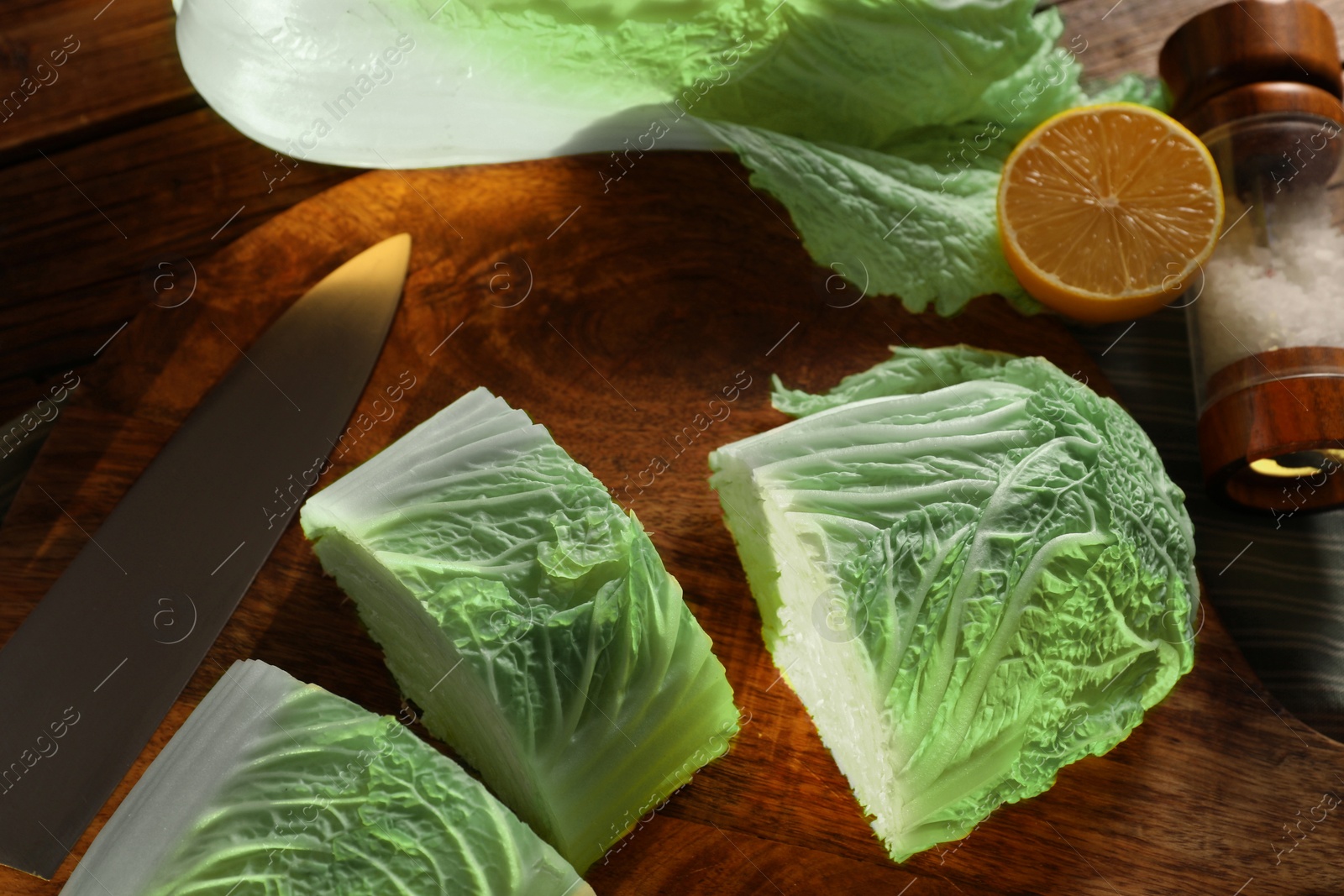 Photo of Fresh Chinese cabbage, knife, salt and lemon on table, top view