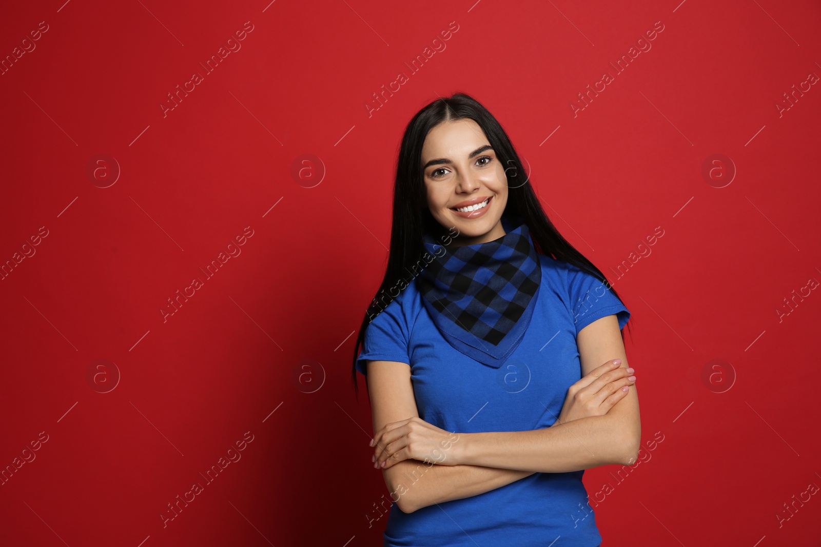 Photo of Young woman wearing stylish bandana on red background, space for text