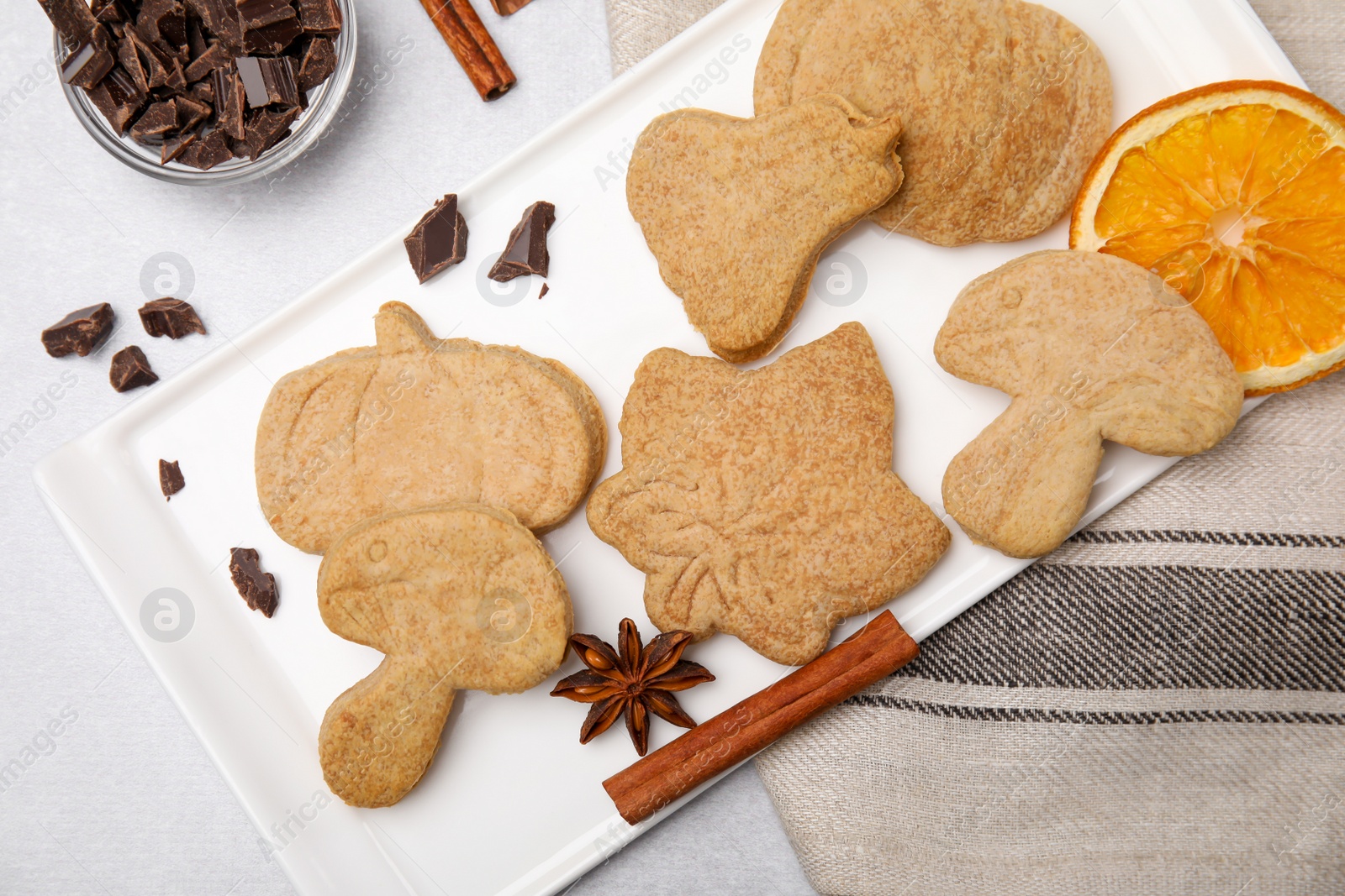 Photo of Flat lay composition with baked biscuits of different shapes on light table