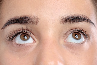 Photo of Young woman with beautiful eyelashes, closeup view