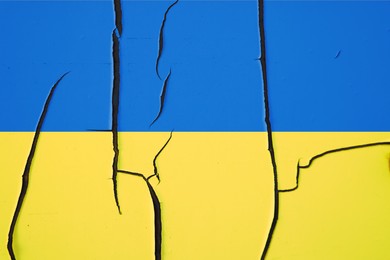 Image of National flag of Ukraine painted on old cracked wall