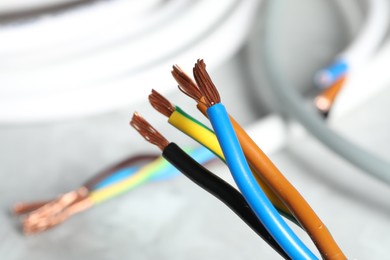 Colorful electrical wires on blurred background, closeup