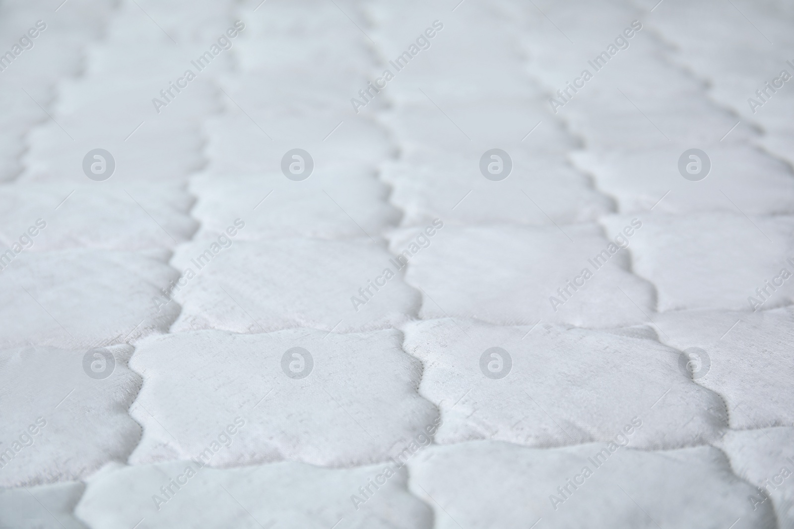 Photo of New white mattress as background, closeup view