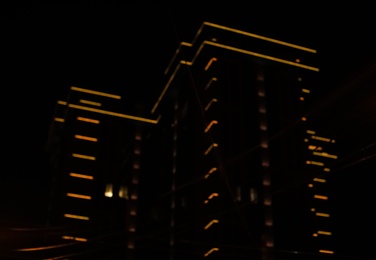Photo of Blurred view of illuminated building at night