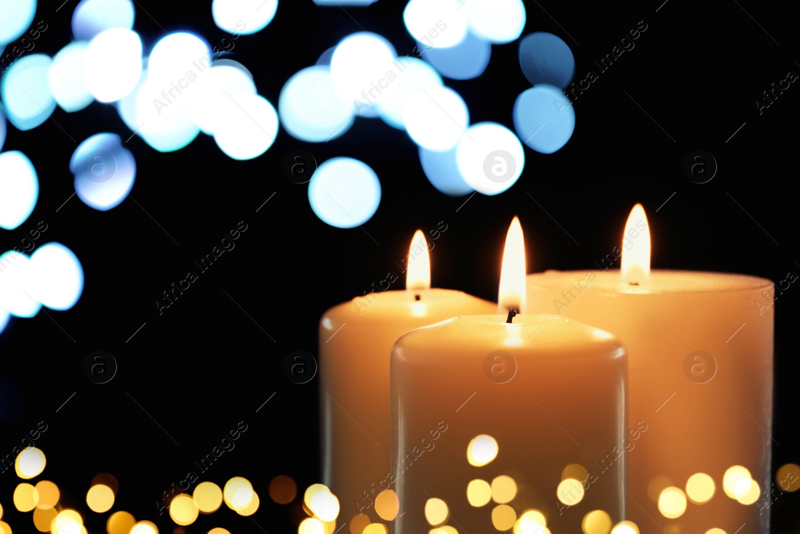 Image of Burning candles on dark background, bokeh effect