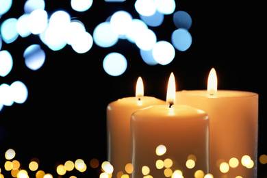 Image of Burning candles on dark background, bokeh effect