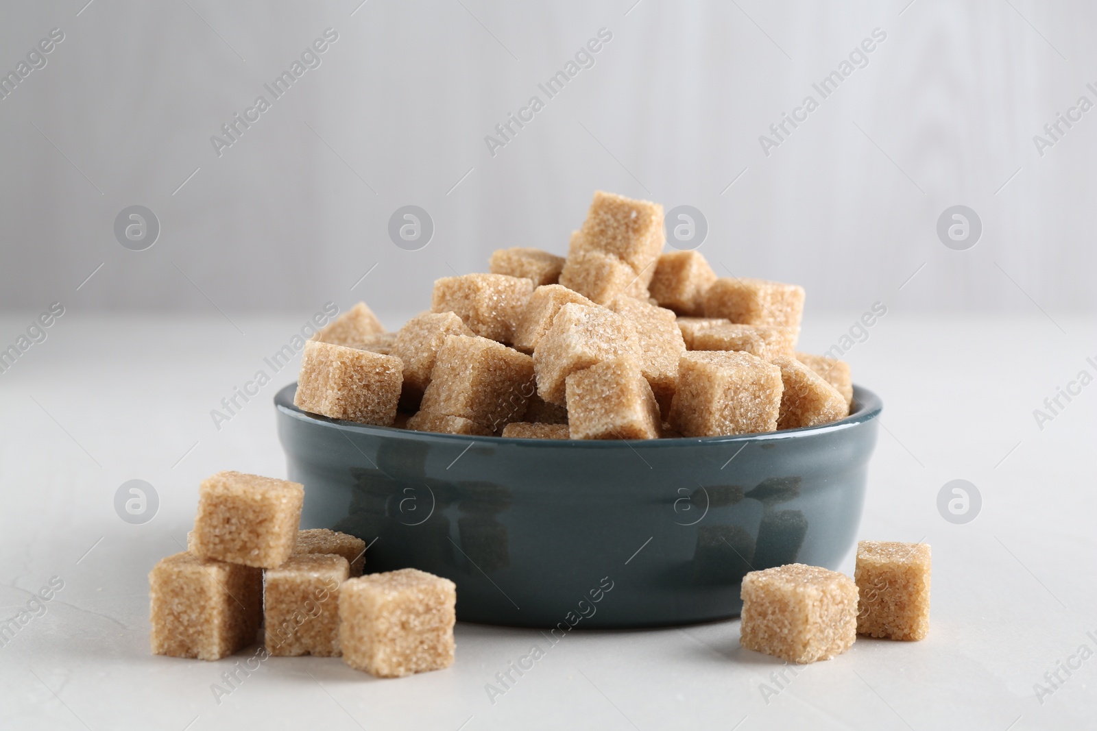 Photo of Brown sugar cubes on light table, closeup