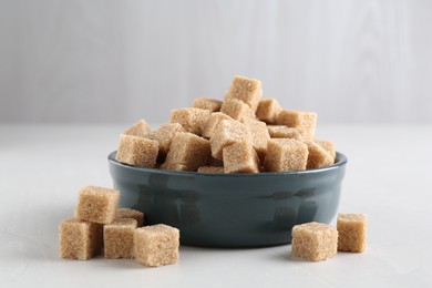 Photo of Brown sugar cubes on light table, closeup