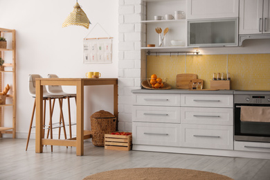 Photo of Modern kitchen interior with stylish wooden table