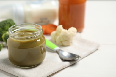 Photo of Healthy baby food and fresh ingredients on white table. Space for text