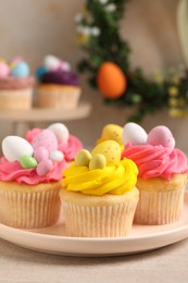 Photo of Tasty decorated Easter cupcakes on table, closeup