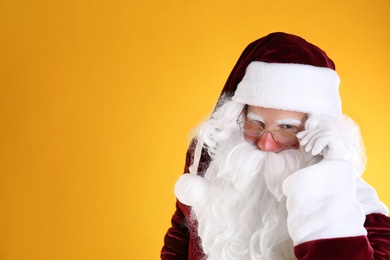 Photo of Portrait of Santa Claus on yellow background. Space for text