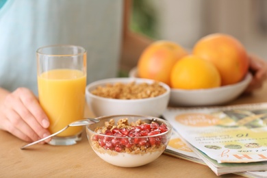 Photo of Young woman having healthy breakfast at home, closeup. Fitness diet