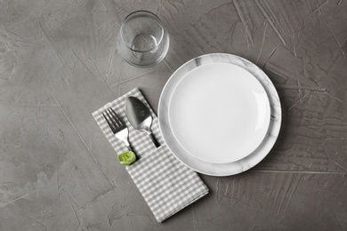 Beautiful table setting on grey background, flat lay