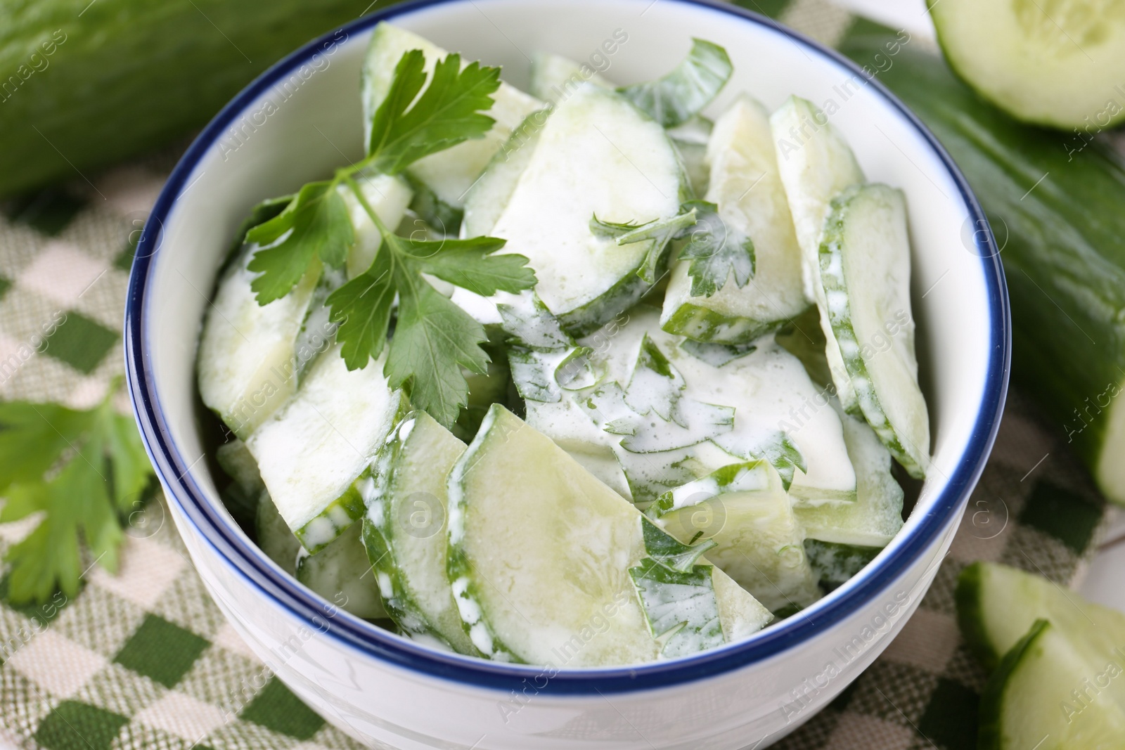 Photo of Delicious cucumber salad in bowl on table, closeup