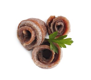 Delicious rolled anchovy fillets and parsley on white background, top view