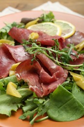 Delicious bresaola salad on table, closeup view
