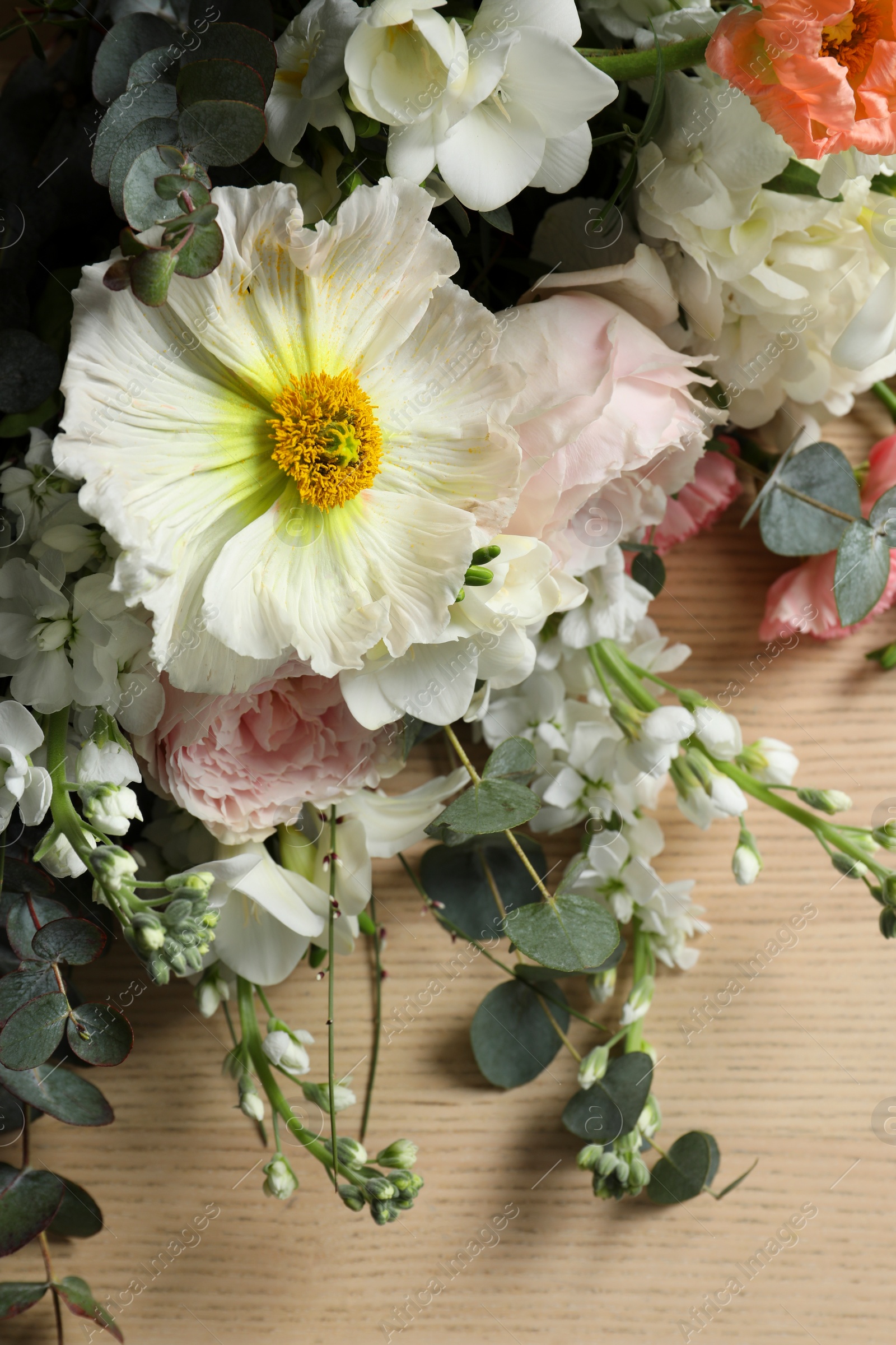 Photo of Bouquet of beautiful flowers on wooden table, closeup