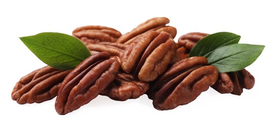 Many tasty pecan nuts with green leaves isolated on white