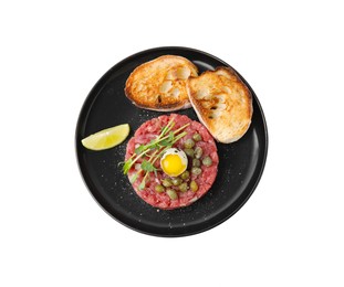 Tasty beef steak tartare served with quail egg, toasted bread and other accompaniments isolated on white, top view