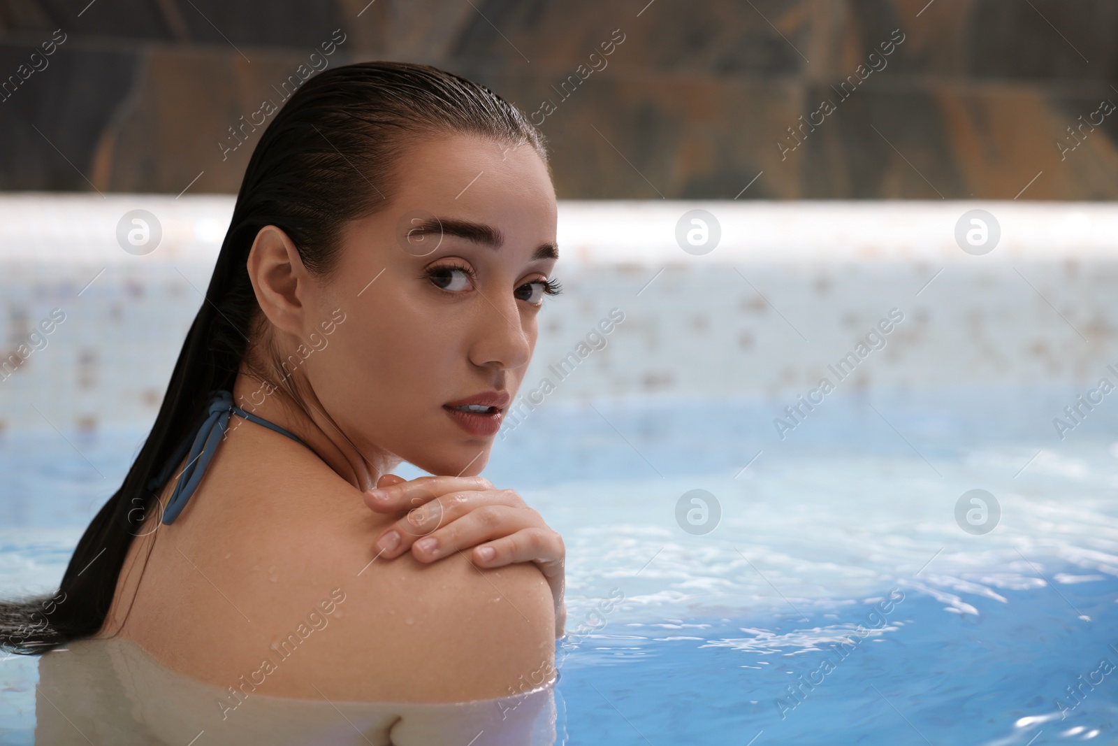 Photo of Beautiful woman in spa swimming pool, space for text