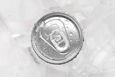 Energy drink in wet can on light background, top view