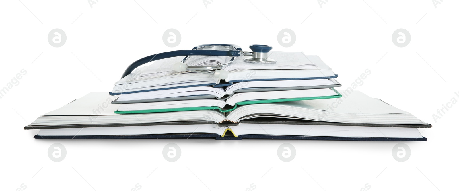 Photo of Stethoscope and stack of open books isolated on white