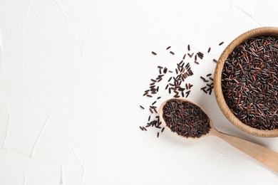 Photo of Flat lay composition with black rice and space for text on white background