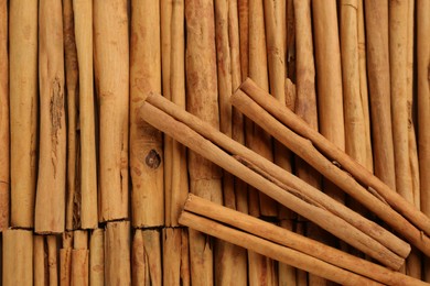 Aromatic cinnamon sticks as background, top view