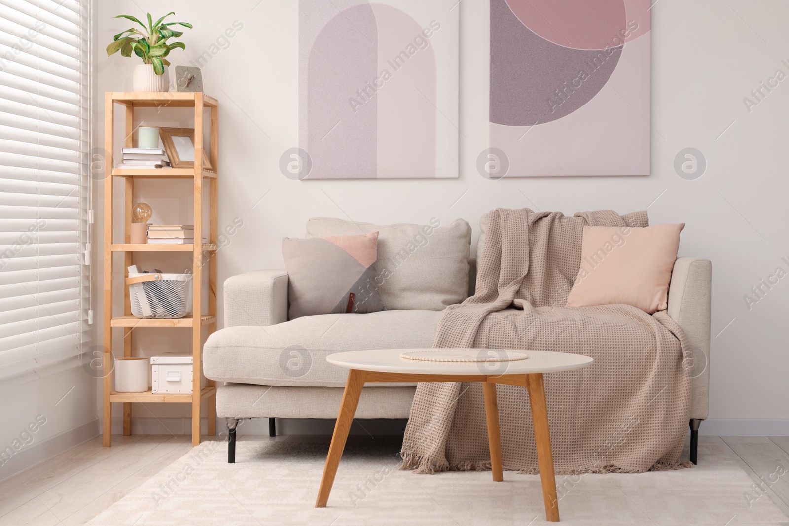 Photo of Stylish living room interior with sofa, coffee table and wooden shelf