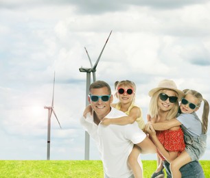 Happy family with children and view of wind energy turbines