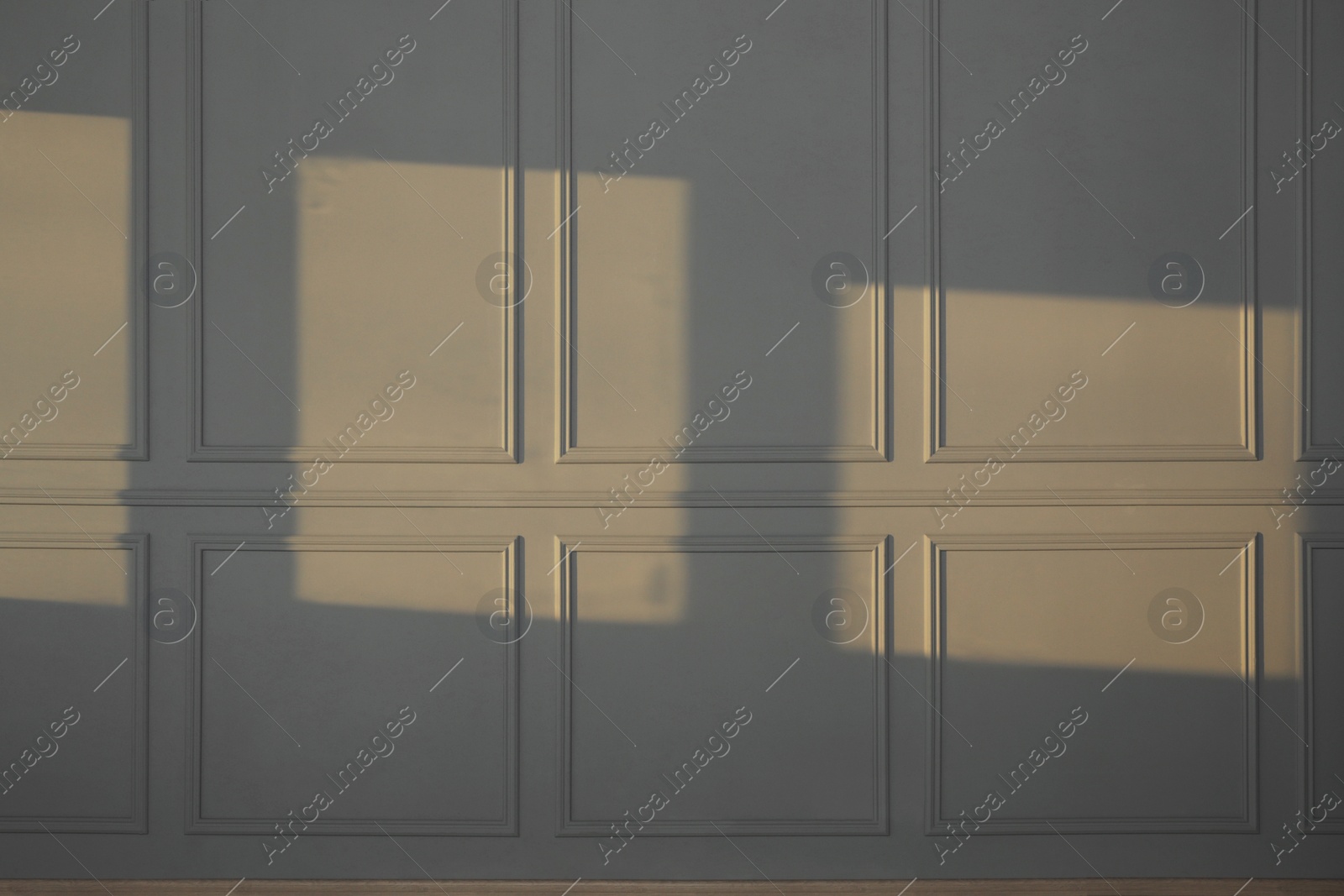 Photo of Light and shadows from window on wall indoors