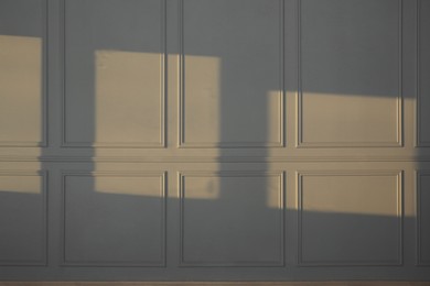 Photo of Light and shadows from window on wall indoors