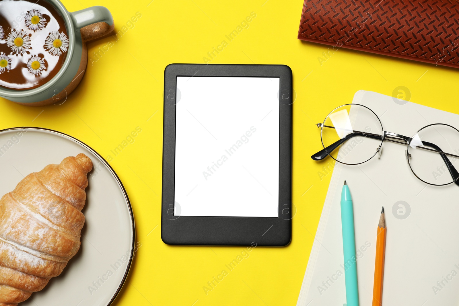 Photo of Flat lay composition with modern e-book reader on yellow background