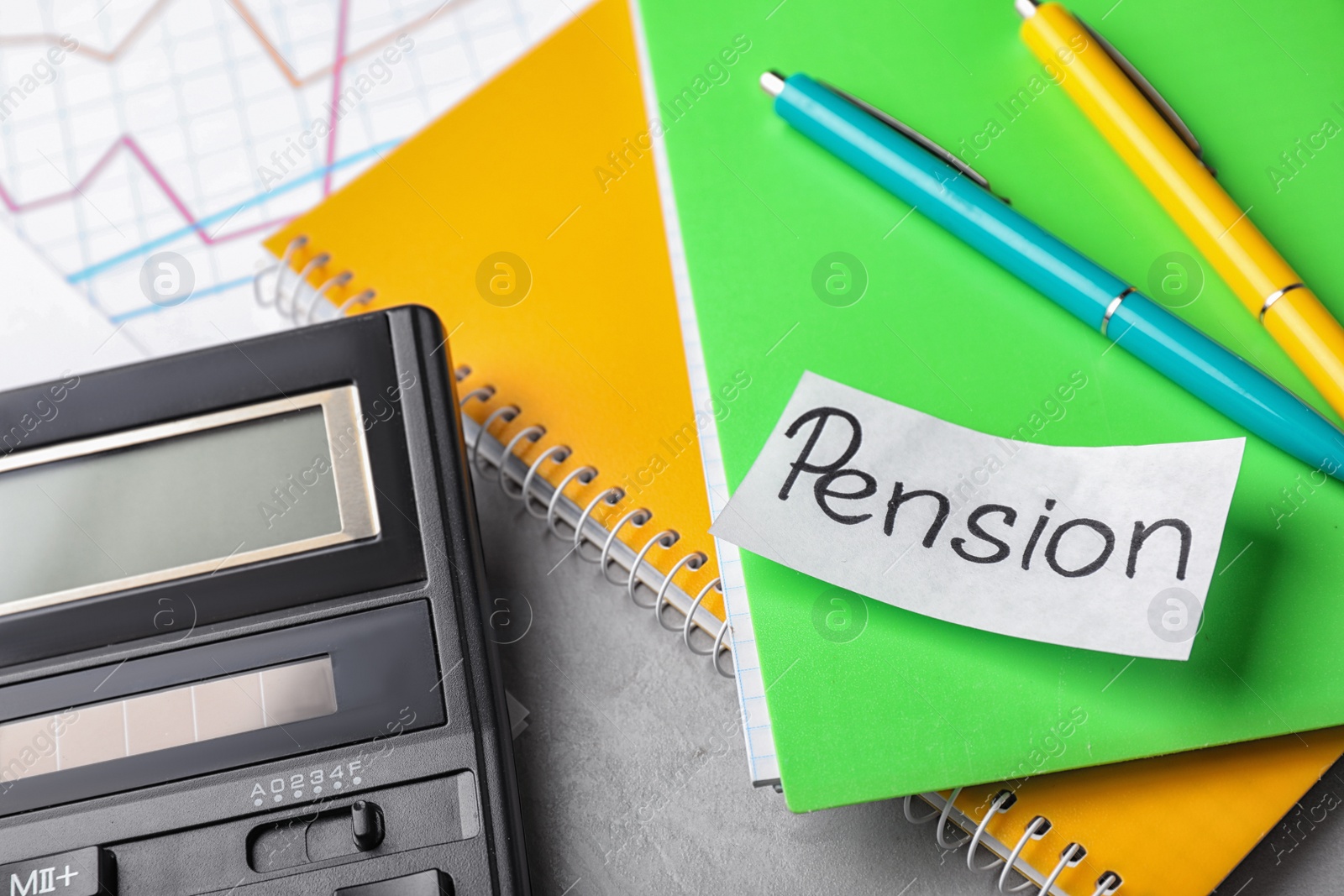 Photo of Paper with word PENSION, stationery, notebooks and calculator on table