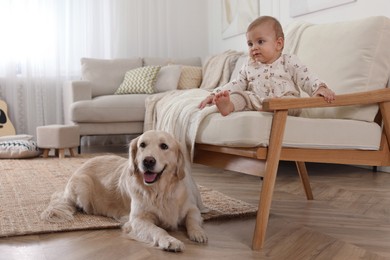 Cute little baby with adorable dog at home