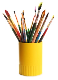 Photo of Holder with different paint brushes on white background